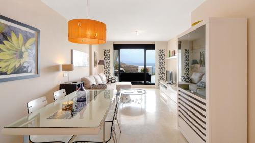 Living and dining area with terrace access and sea view