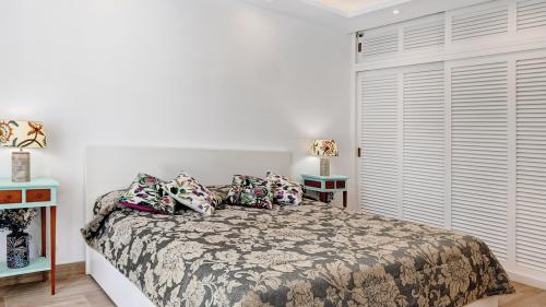 Master bedroom with colourful artwork and French doors to the terrace