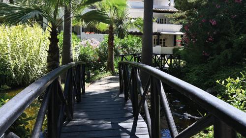 Wooden footbridge over a koi pond in the resort's landscaped gardens