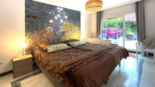 Master bedroom with floral feature wall and terrace access