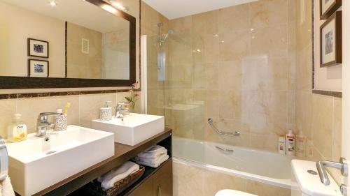 Bathroom with double vanity, shower and bathtub