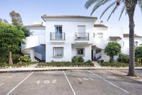 View of the apartment building with private parking