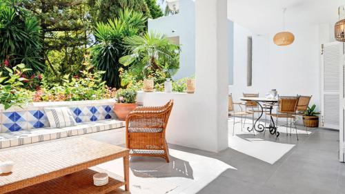 Covered terrace lounge with tiled bench and garden view
