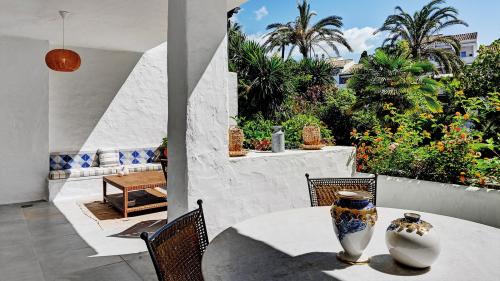 Terrace dining table with decorative vases and garden view