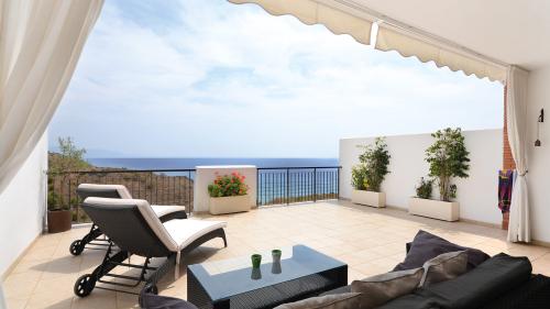 Terrace with sun loungers and sea view