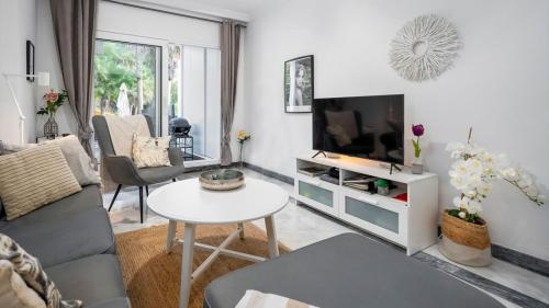 Living room with sofa, TV and terrace view