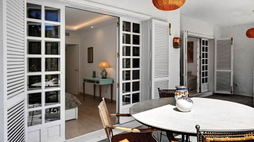 Terrace dining area seen through French doors from the hallway