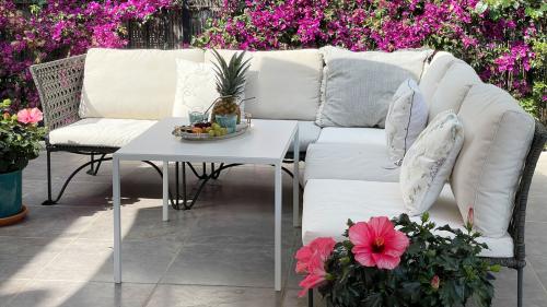 Terrace lounge corner surrounded by bougainvillea