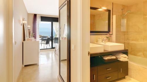 Dressing area leading to the en-suite bathroom, with sea-view bedroom beyond