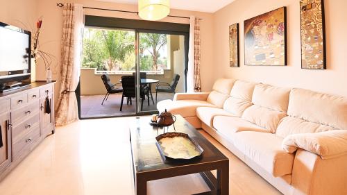 Living room with sofa and open view to the kitchen
