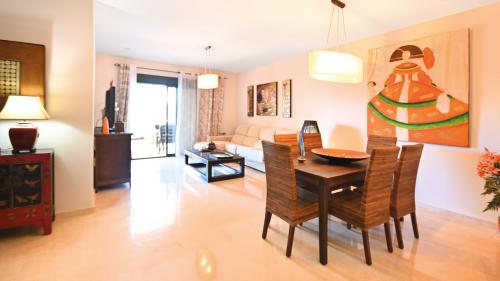 Dining and living area with pendant lighting and decorative wall art