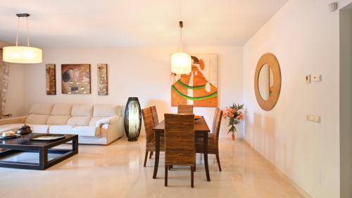 Round dining table with decorative centerpiece, seating for six