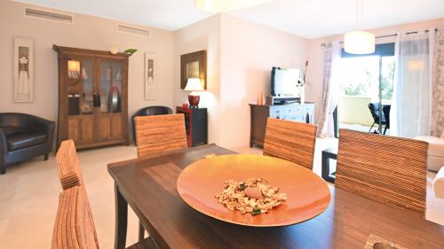 Dining nook with round table, TV and wooden cabinet
